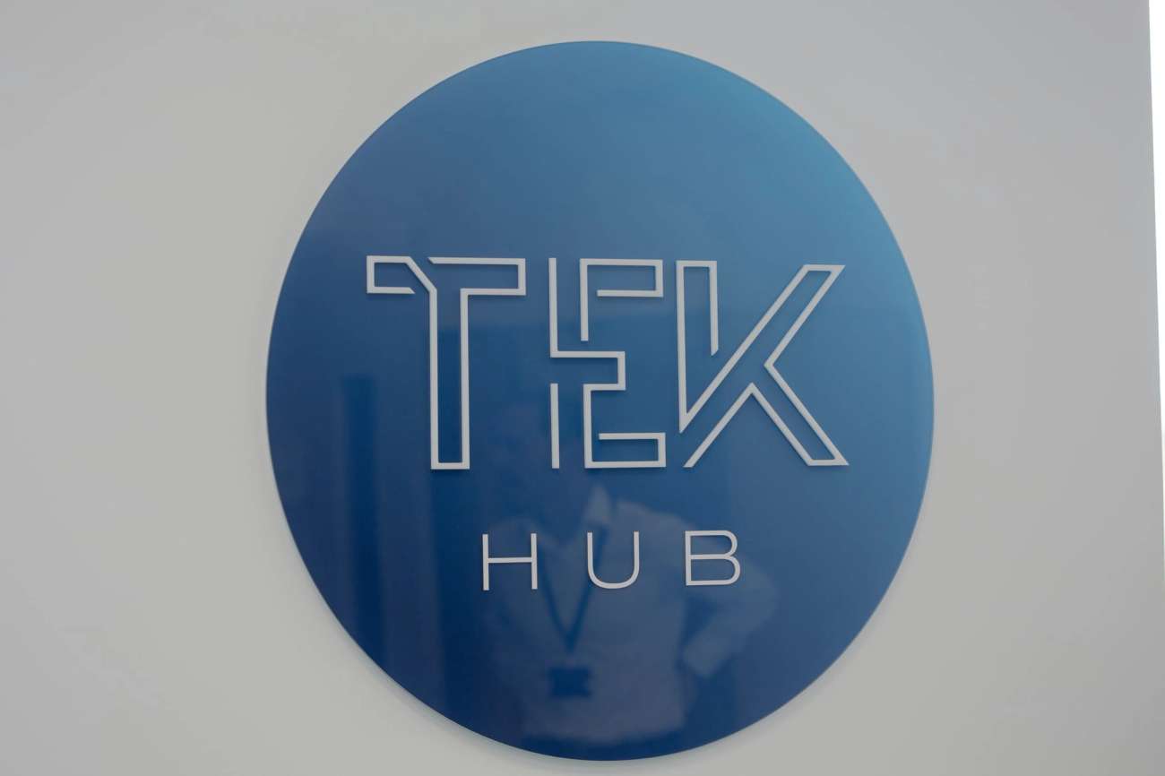 Round TEK-HUB logo on wall