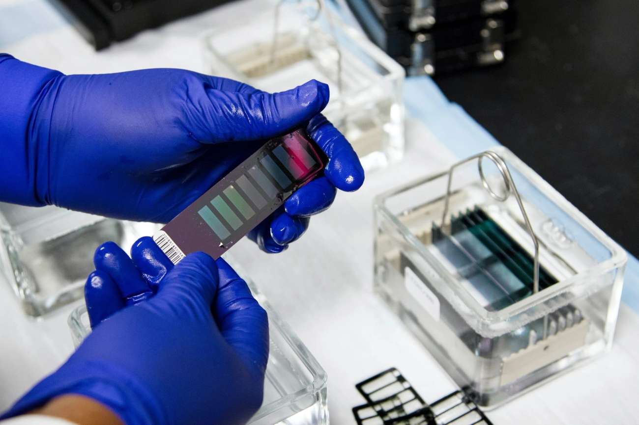 Person with gloves with testing device